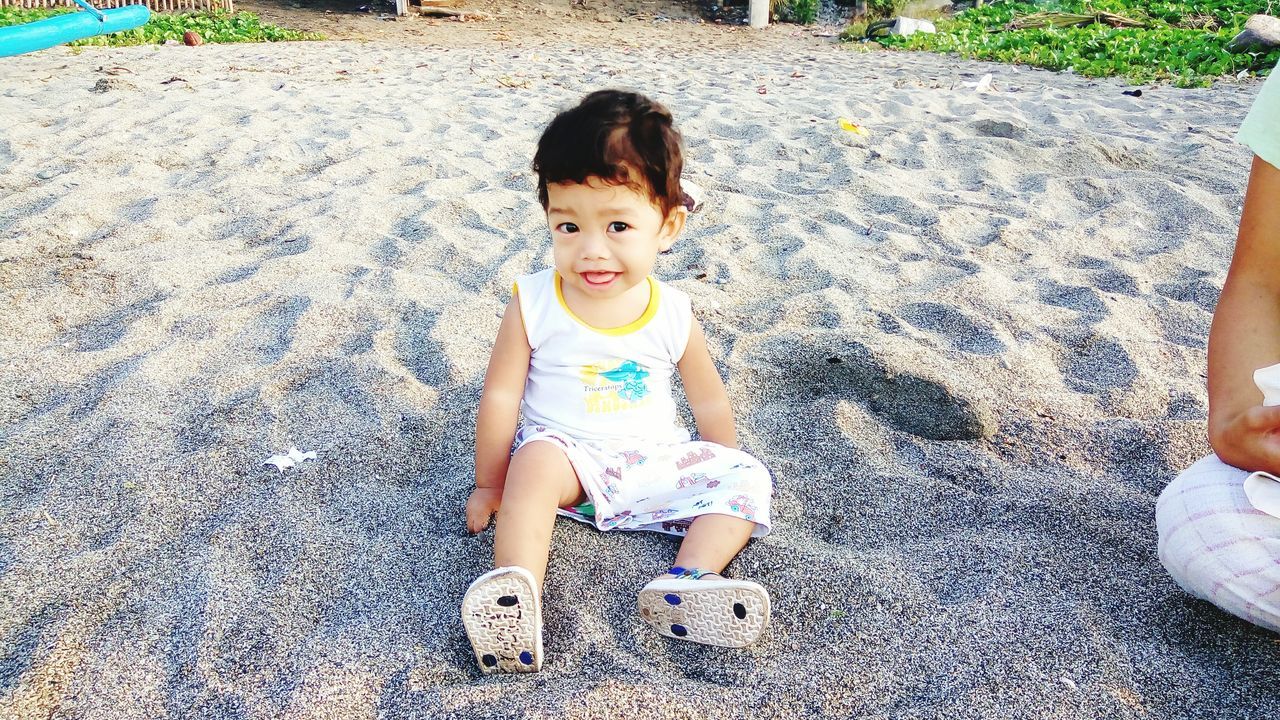 HIGH ANGLE VIEW OF GIRL HOLDING TOY WHILE STANDING OUTDOORS