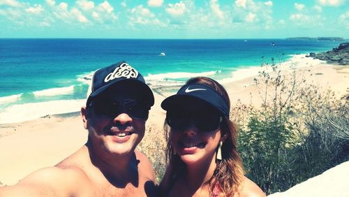 Portrait of smiling young couple on beach