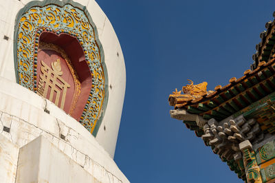 Low angle view of temple against clear blue sky