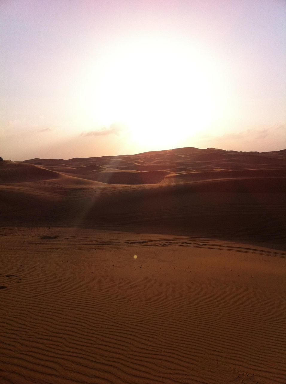 sand, tranquil scene, tranquility, sand dune, landscape, desert, scenics, sunset, beauty in nature, arid climate, nature, beach, sky, sunlight, horizon over land, remote, sun, idyllic, non-urban scene, clear sky