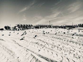 Panoramic view of people on beach against sky
