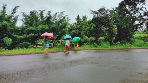 Rear view of people walking on road