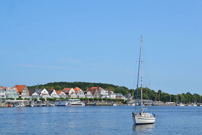 View of buildings against clear blue sky