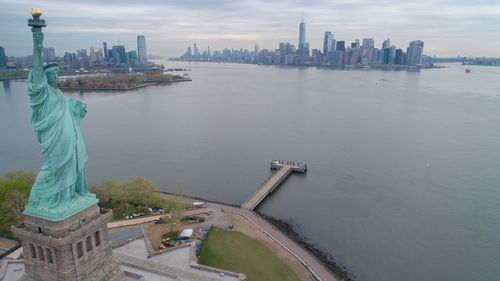 Statue of liberty at waterfront in city