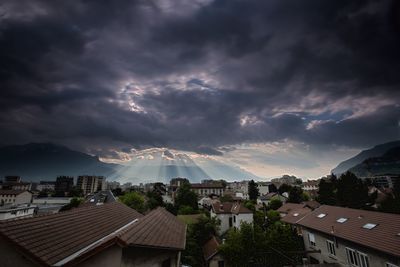 Panoramic view of townscape against cloudy sky at dusk