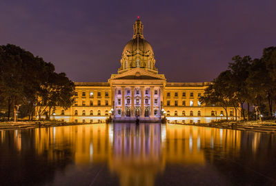 Illuminated alberta legislature building against sky at night