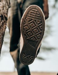 Close-up of shoes hanging on wood