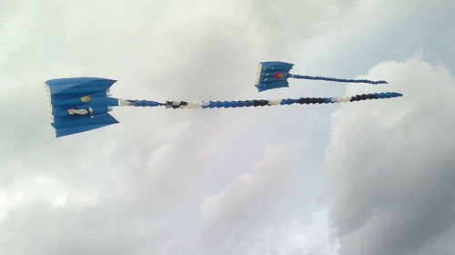 Low angle view of airplane flying against sky