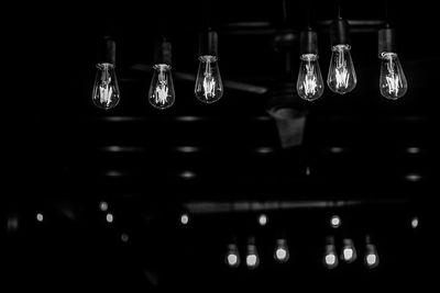 Close-up of illuminated lights hanging in row