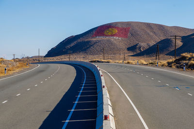 Empty road against clear sky