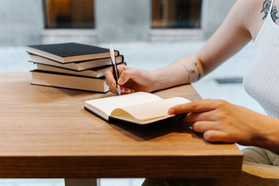 Young woman reading books in a coffee shop