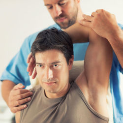Man receiving massage therapy in spa