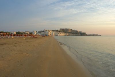 Scenic view of beach against sky during sunset