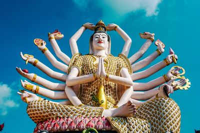 Low angle view of statue against blue sky