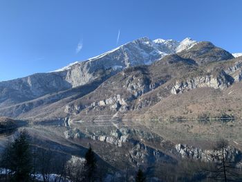 Scenic view of snowcapped mountains against clear blue sky