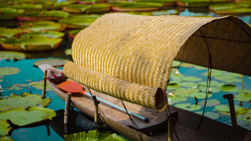 Close-up of hat on boat moored in lake