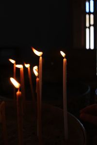 Close-up of lit candles in temple