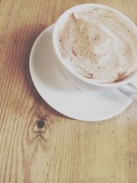 Close-up of coffee cup on wooden table