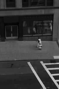 Rear view of boy walking on street