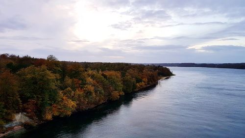 Scenic view of river and landscape against sky