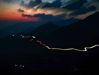 Scenic view of silhouette mountains against sky at night