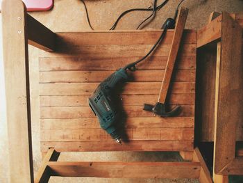 Directly above shot of drill machine with hammer on table