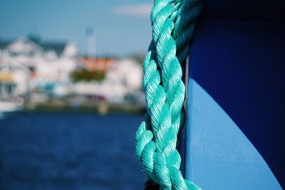 Close-up of rope against blue sea