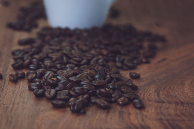 Close-up of roasted coffee beans on table