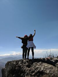 Full length of men standing on rock