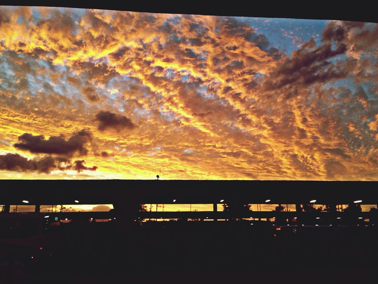 sunset, silhouette, sky, cloud - sky, orange color, low angle view, beauty in nature, scenics, dramatic sky, dark, nature, cloud, cloudy, built structure, dusk, no people, outdoors, tranquility, tranquil scene, architecture