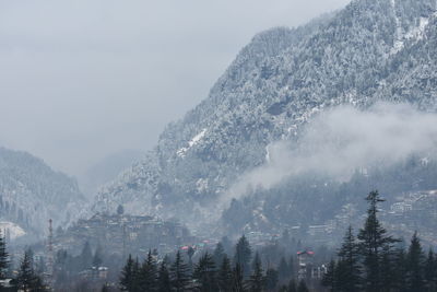 Scenic view of snow covered mountains against sky