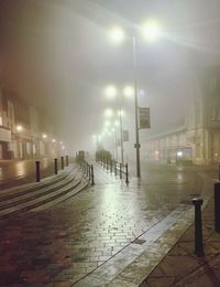 Illuminated street lights in city at night