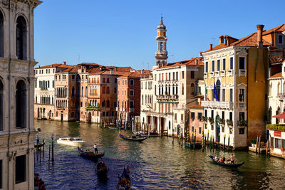 Boats in canal along buildings