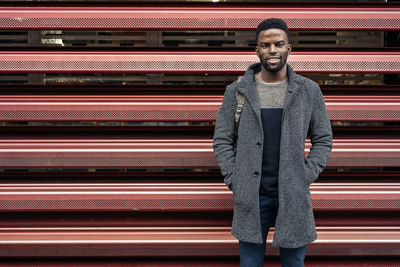 Portrait of laughing young man standing outdoors