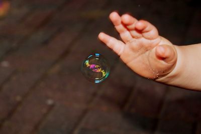 Close-up of hand holding bubbles