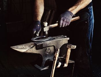 Cropped hand of man working at workshop