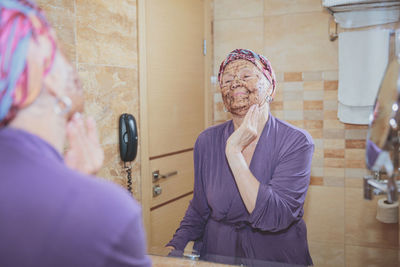 Elderly woman taking care of her face