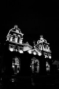 Low angle view of illuminated building against sky at night