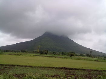 Scenic view of mountains against cloudy sky