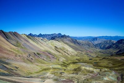 View of mountain range against blue sky