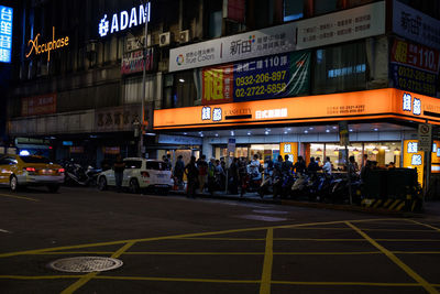 People on road in city at night