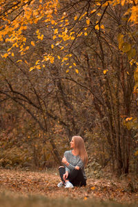 Woman with autumn leaves in foreground