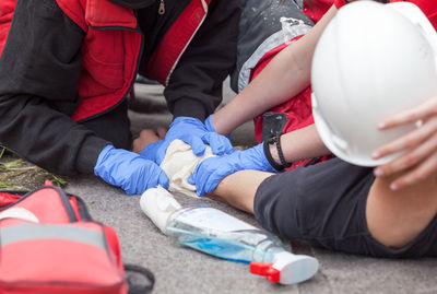 Midsection of man cleaning blood on person hand