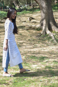 Full length of woman standing on field