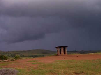 Abandoned built structure on field against sky