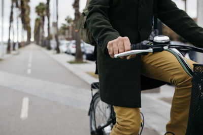 Close-up of man riding e-bike on a promenade