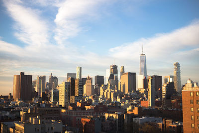 View of cityscape against cloudy sky