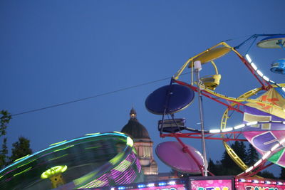 Low angle view of ferris wheel against clear blue sky