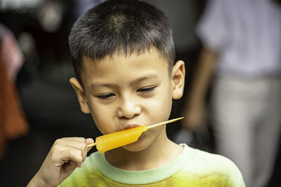 Close-up portrait of boy eating food