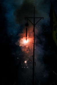 Low angle view of fireworks against sky at night